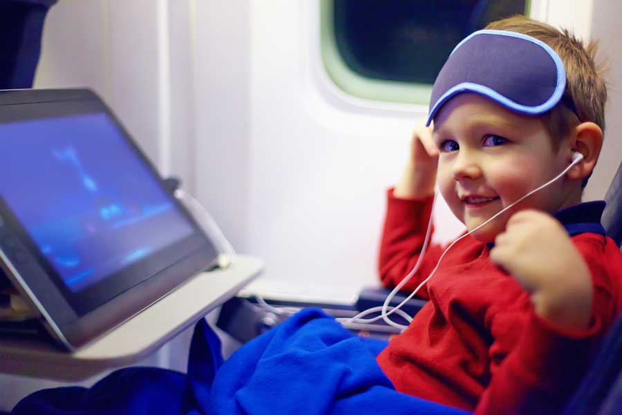 A kid watching cartoons during a flight