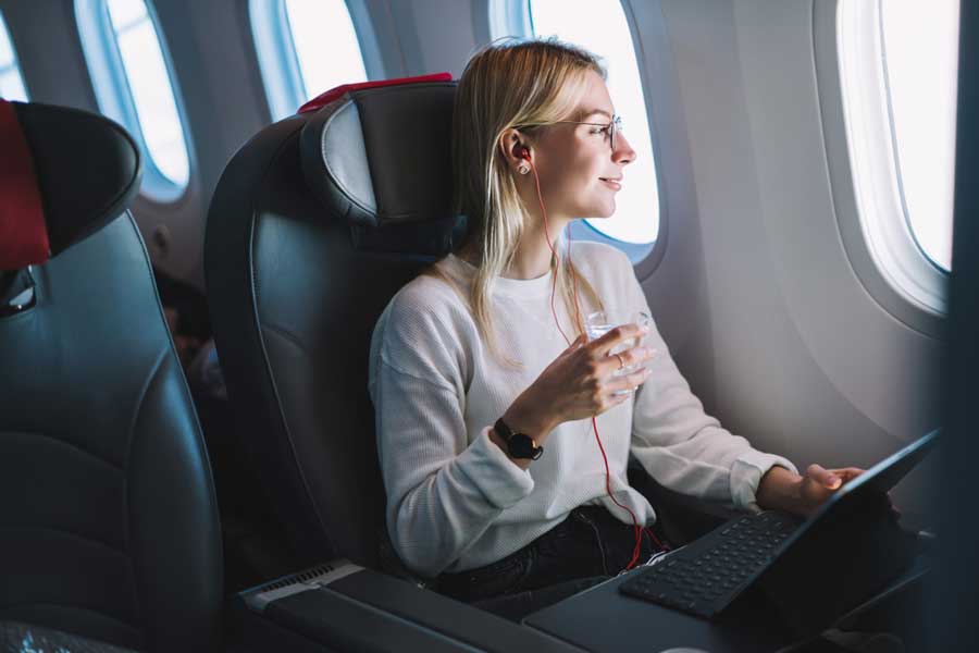 A woman using her laptop during a flight