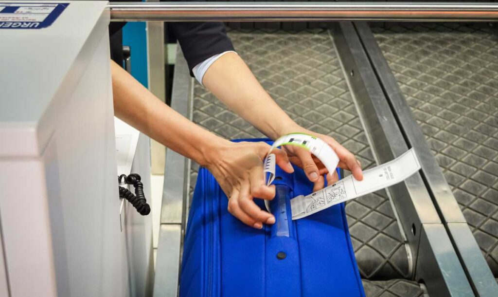 An airport staff checking the luggage tag