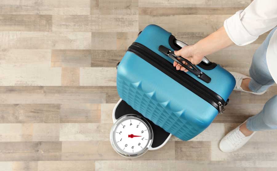 A woman weighing her luggage