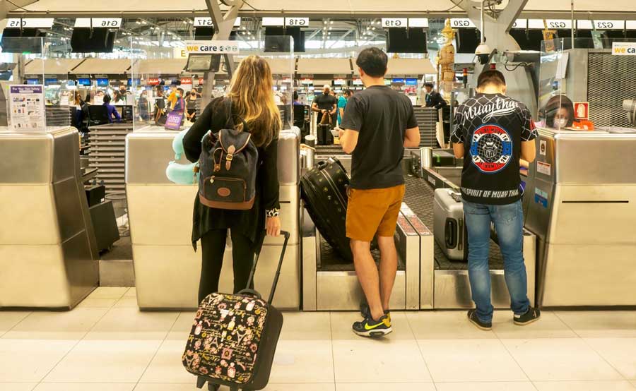 Passengers waiting for their luggage to be check