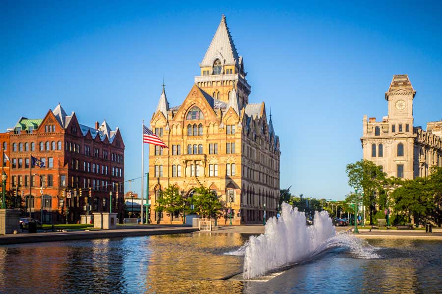 Clear blue sky over the historic buildings and fountain in Downtown Syracuse