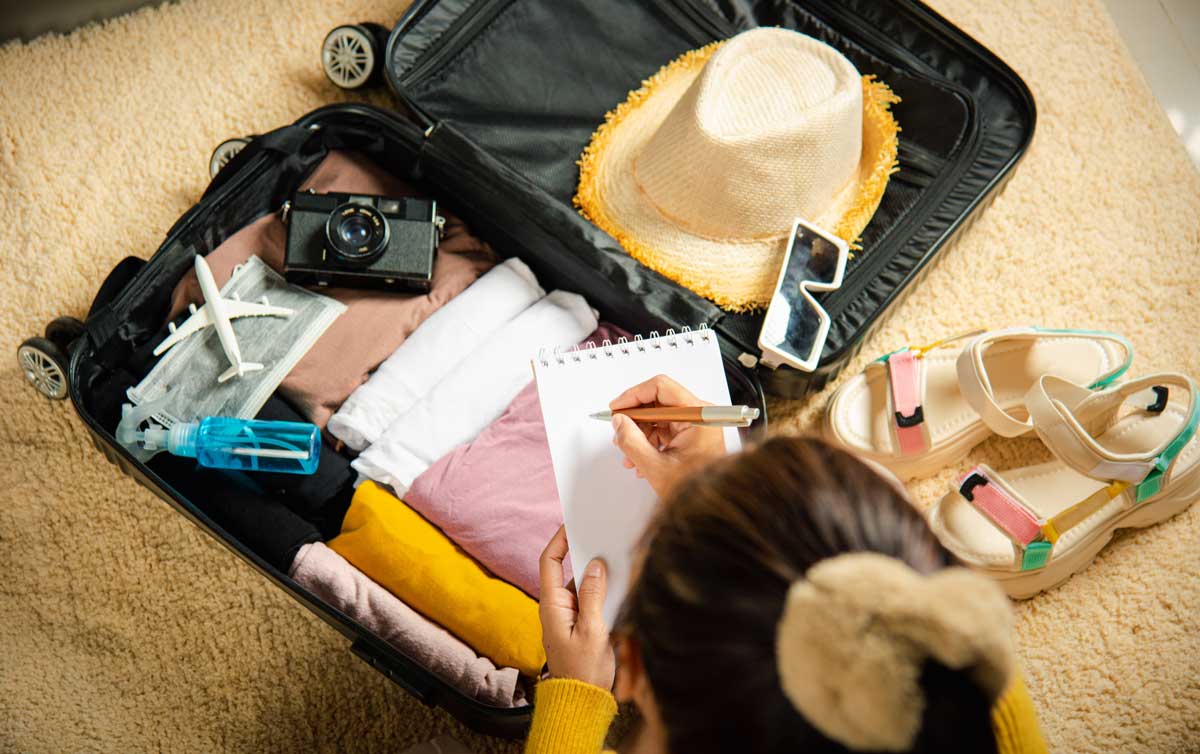 A woman packing her travel essentials for a trip